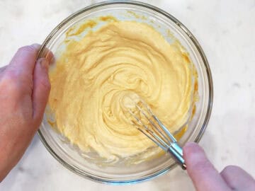 Mixing the frosting in a bowl.