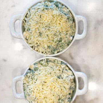 The mixture was added to the baking dishes and topped with cheese.
