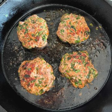 Pan frying the burgers.