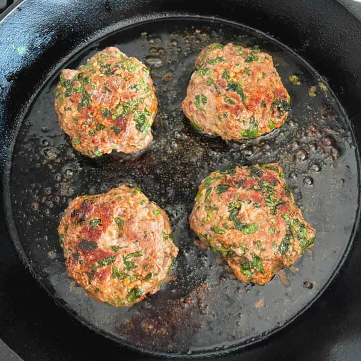 Pan frying the burgers.