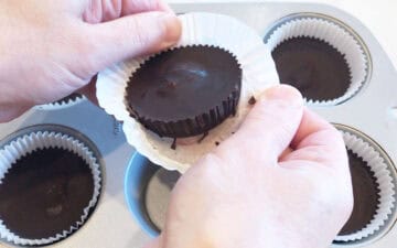 Removing a peanut butter cup from the paper liner.