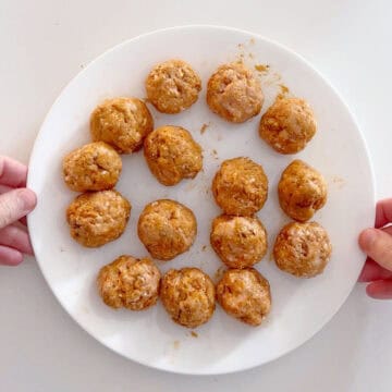 The meatballs were shaped and placed on a white plate.