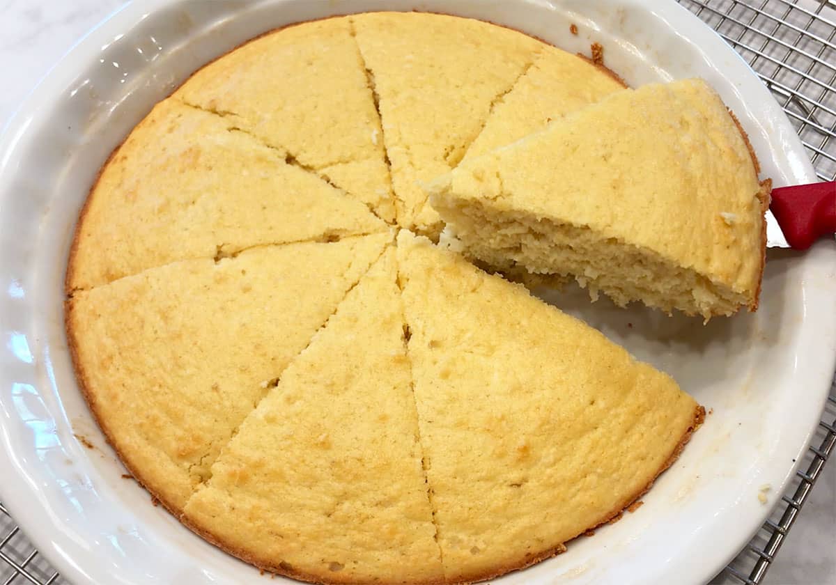 Slicing the cake in the pan.