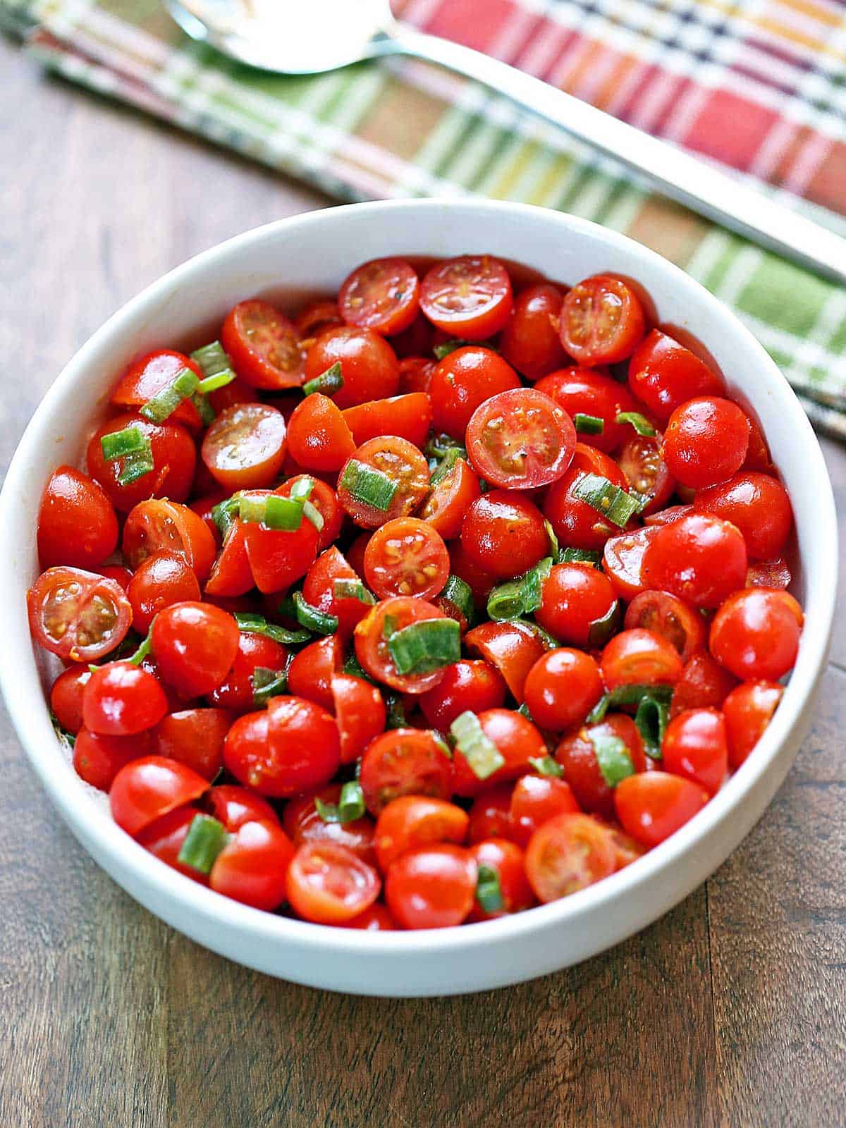 Tomato salad is served in a bowl.