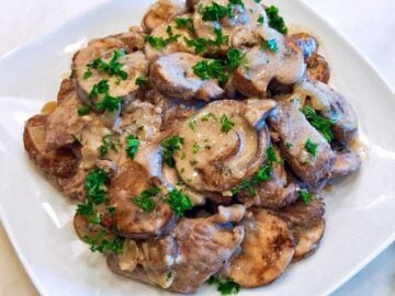 Beef stroganoff is served on a white plate.