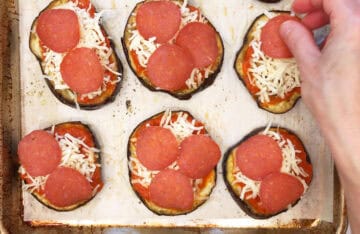 Adding toppings to the pizza.