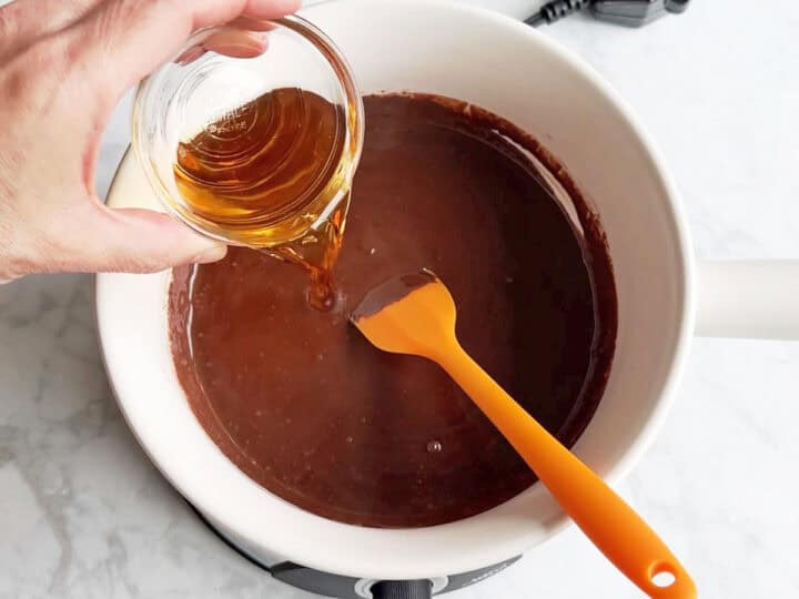 Adding vanilla to the fondue pot.