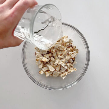 Adding water to the matzo pieces.