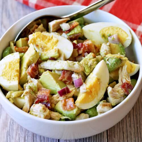 Avocado chicken salad is served in a white bowl.