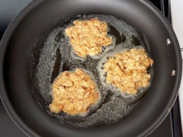 Cooking the matzo brei in butter in a skillet.
