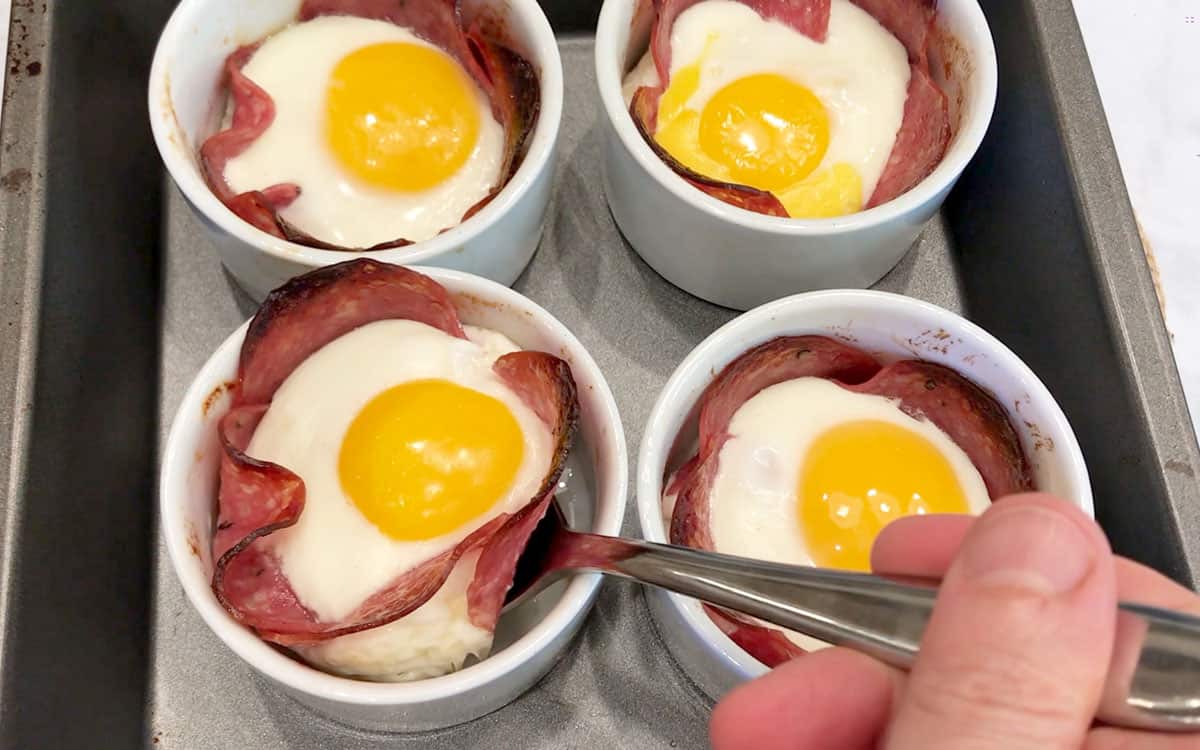 Removing the salamin and egg cups from the ramekins.