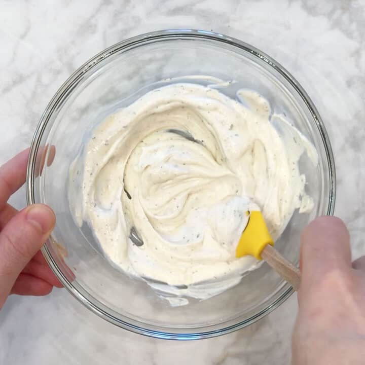 Mixing the tartar sauce ingredients in a bowl.