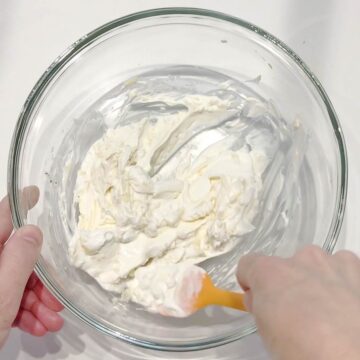 Mixing the sauce in a bowl.