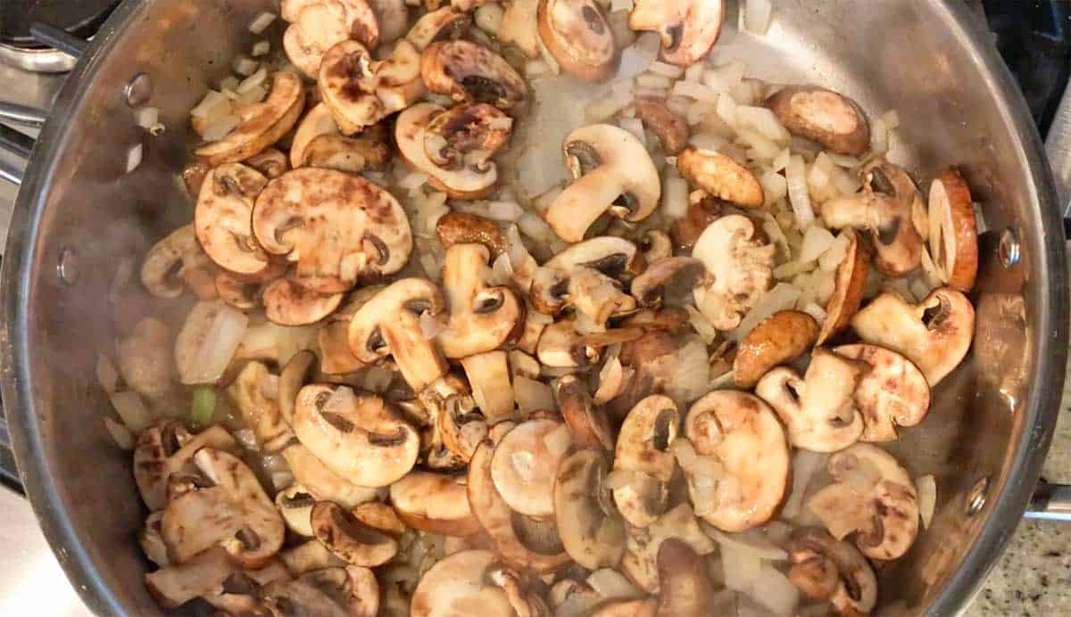 Cooking the mushrooms and onions.