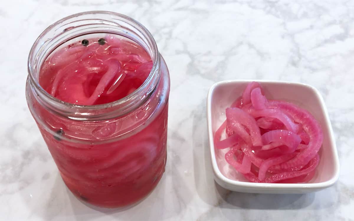 Pickled red onions are served.