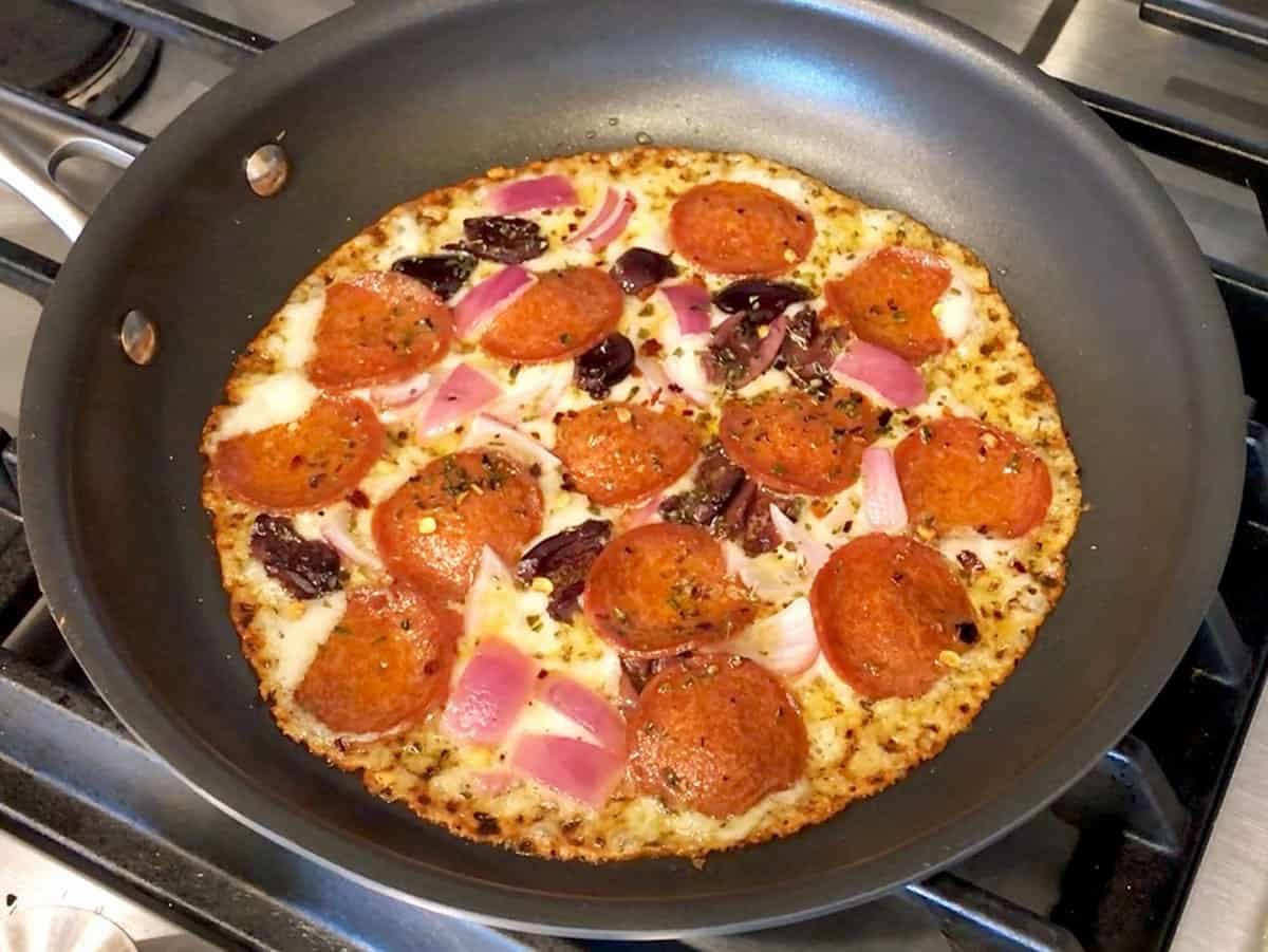 The pizza is ready in the skillet.