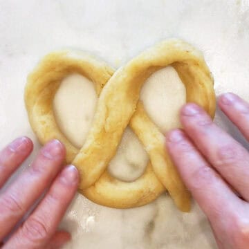 Shaping the dough into pretzels.