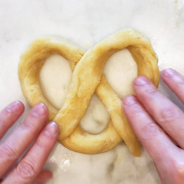 Shaping the dough into pretzels.
