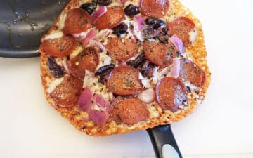 Sliding the pizza to a cutting board.