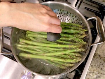 Placing the steamer basket in the saucepan.
