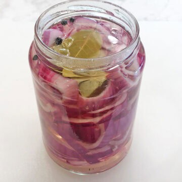 The water-vinegar solution was added to the jar with the red onions.