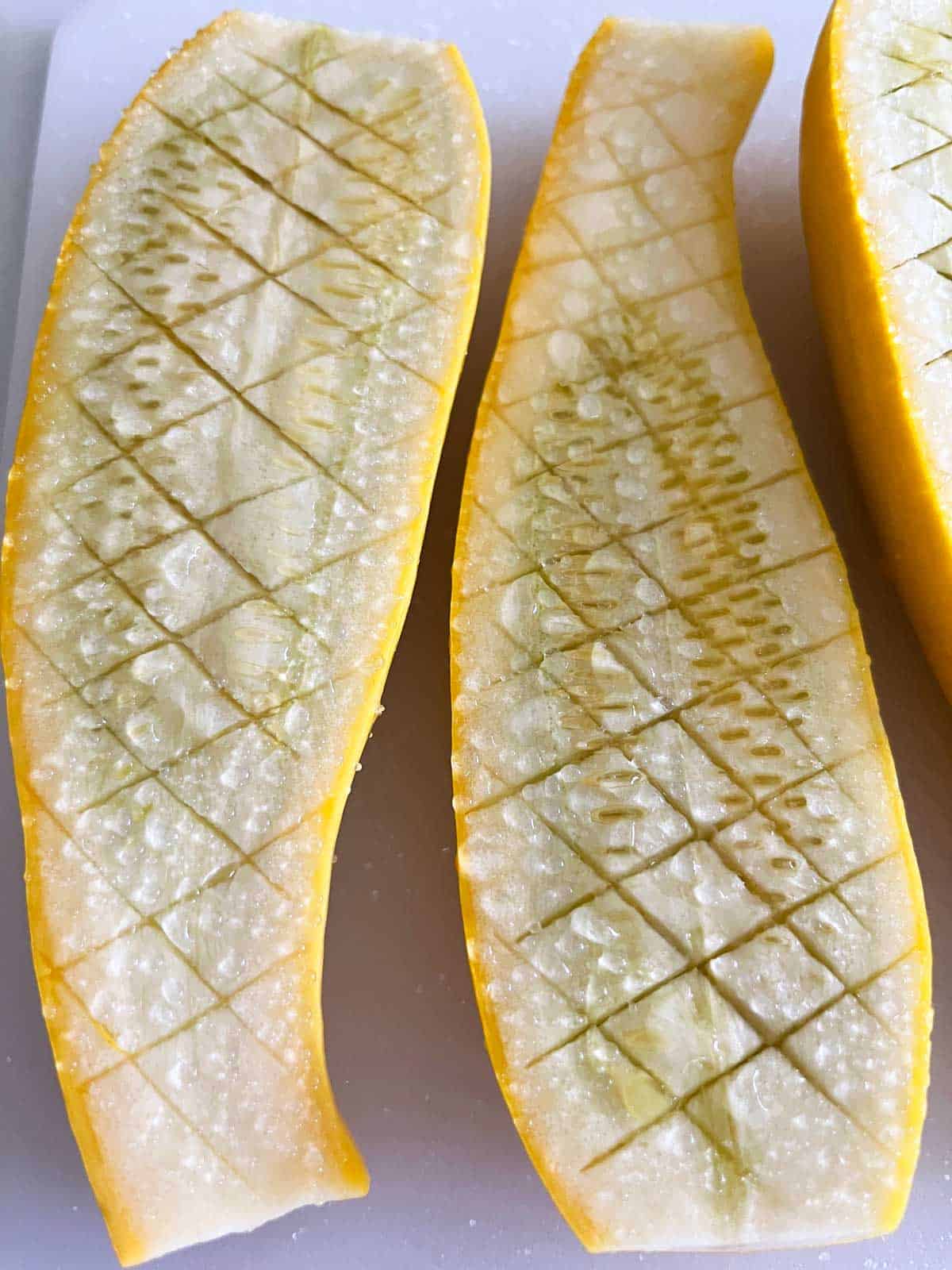 Salted yellow squash with visible water droplets on top.