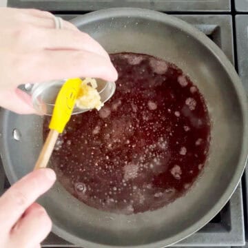 Adding garlic to the skillet.