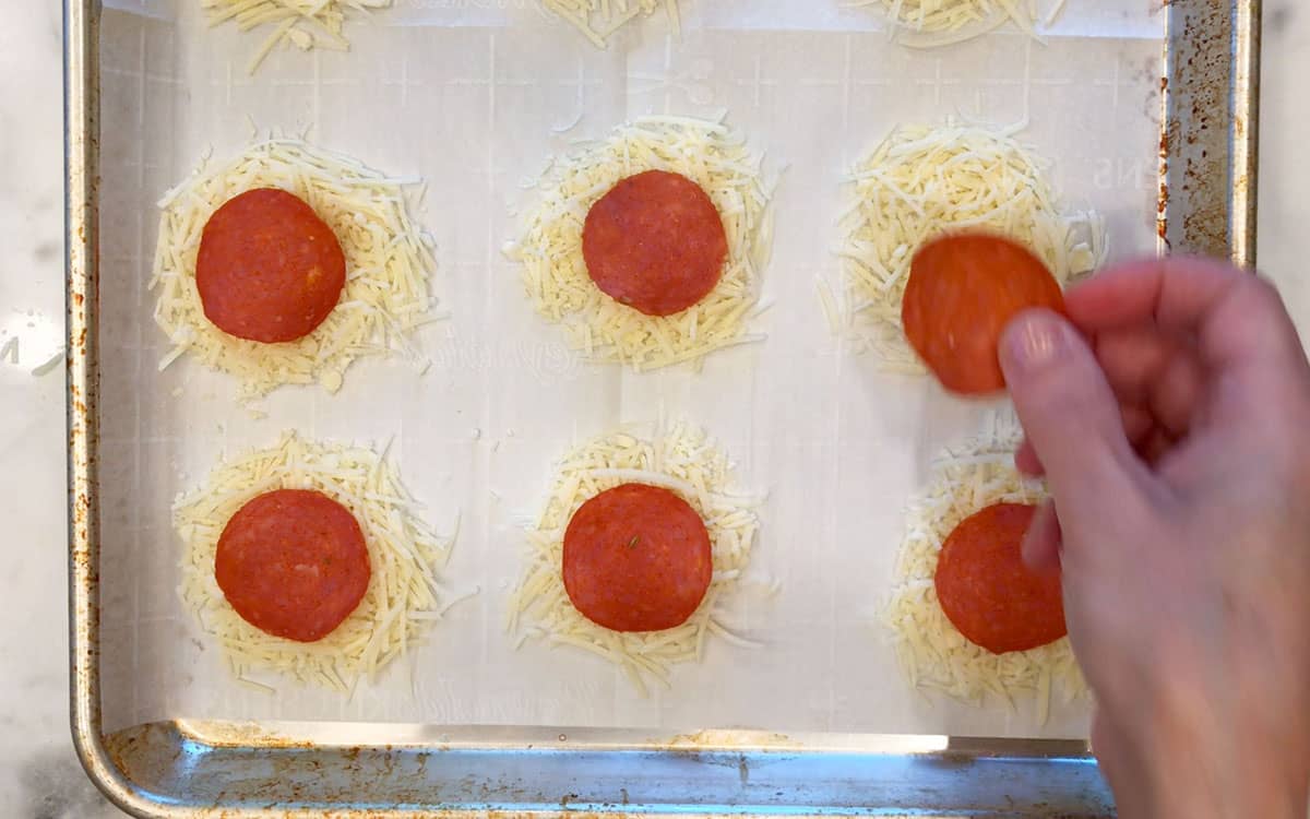 Adding pepperoni to the crisps.