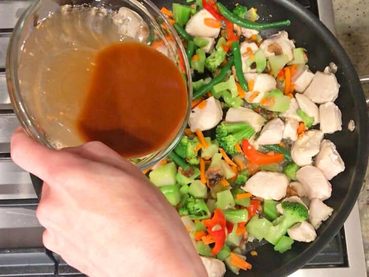 Adding the sauce to the skillet.