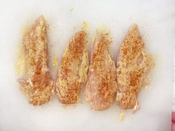 The chicken tenders were coated in mustard and spices.