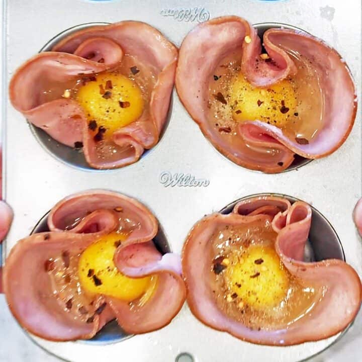 Eggs were added to the cups and seasoned with spices.