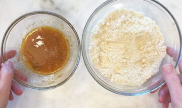 A bowl with almond flour and a bowl with an egg/spice mixture.