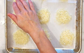 Flattening the cheese mounds.