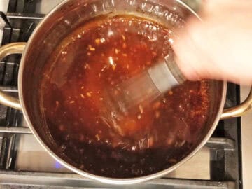 Mixing the teriyaki sauce ingredients in a saucepan.