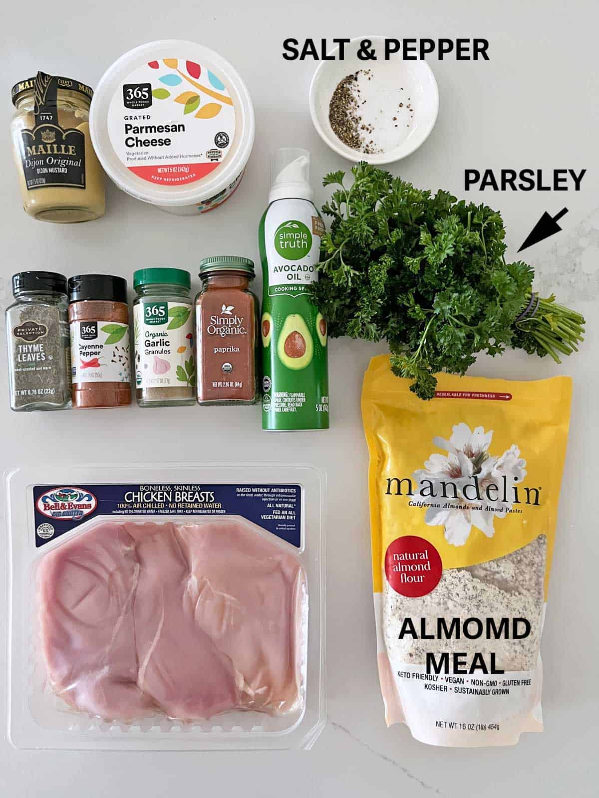 The ingredients needed to make parmesan-crusted chicken.