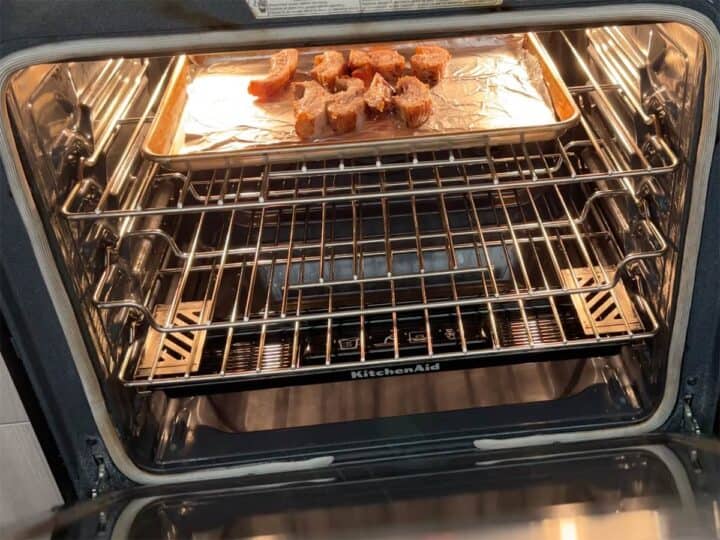 Placing the sliced pork jowl under the broiler.