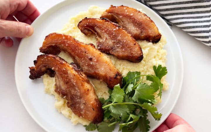 POrk jowl is served on a bed of mashed cauliflower.