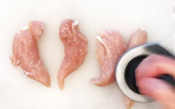 Pounding the chicken tenders.