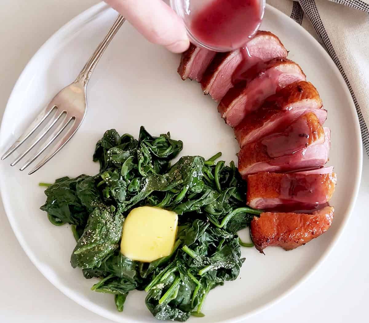 Pouring the sauce on the duck.