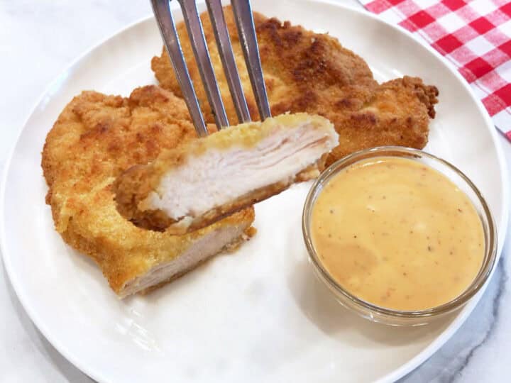 The chicken tenders are served with a dipping sauce.