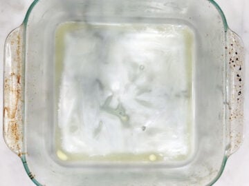 A buttered 8-inch square baking dish.