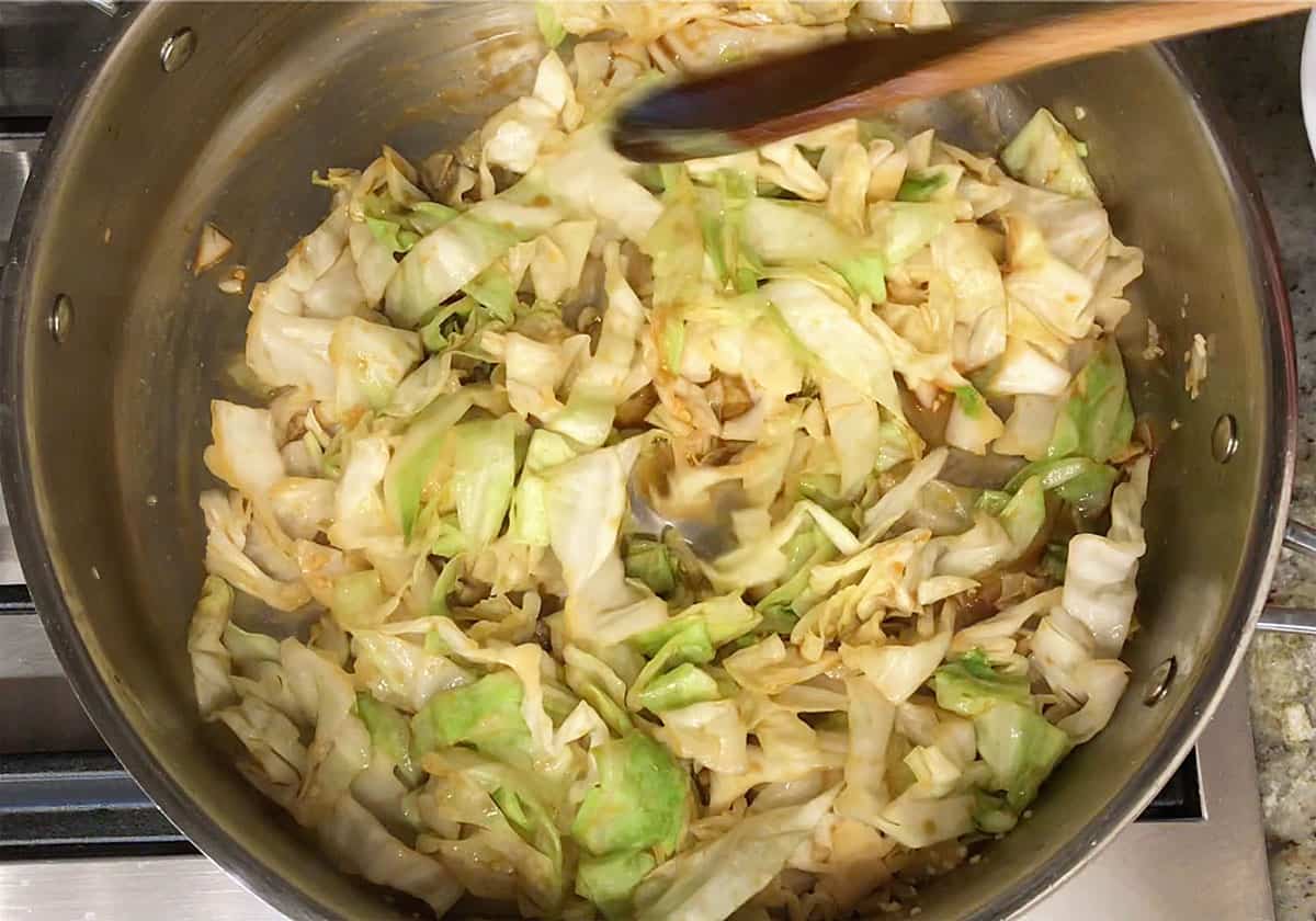 The sauce was added to the cabbage in the skillet.