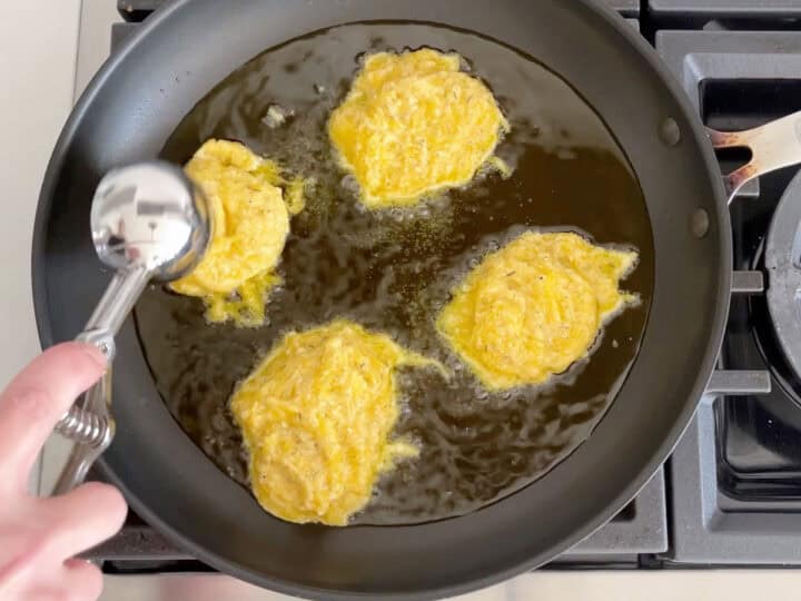 Adding mounds of the mixture to a skillet.