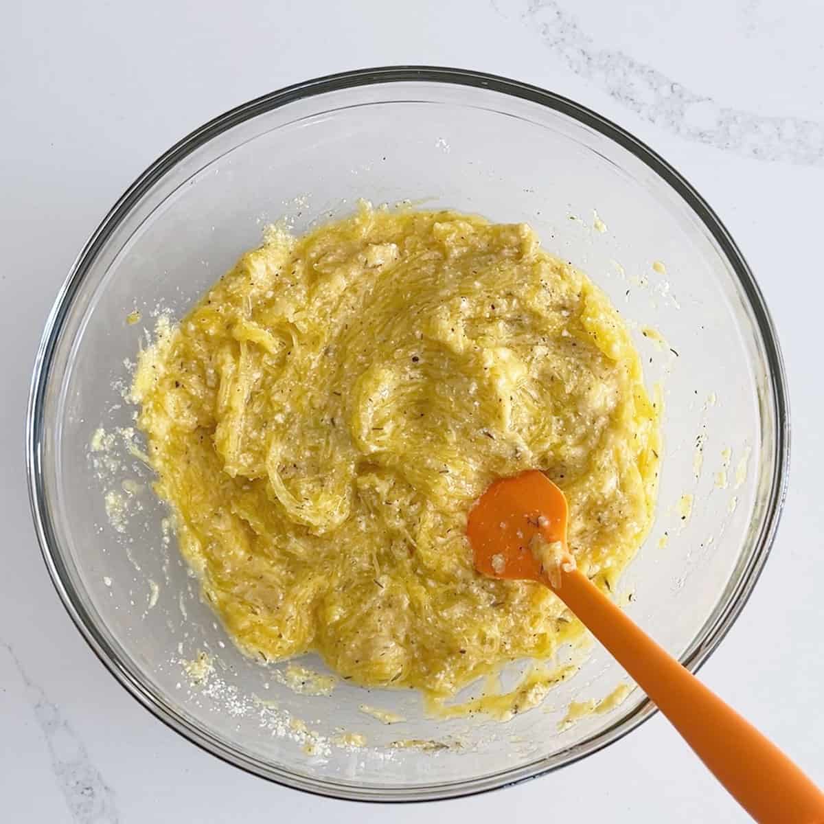 The mixture in the bowl has a thick texture.