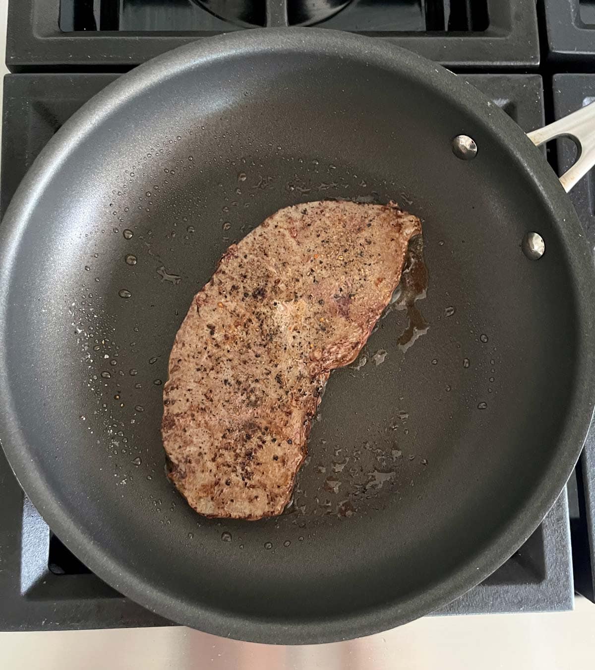 Cooking beef liver in a skillet.