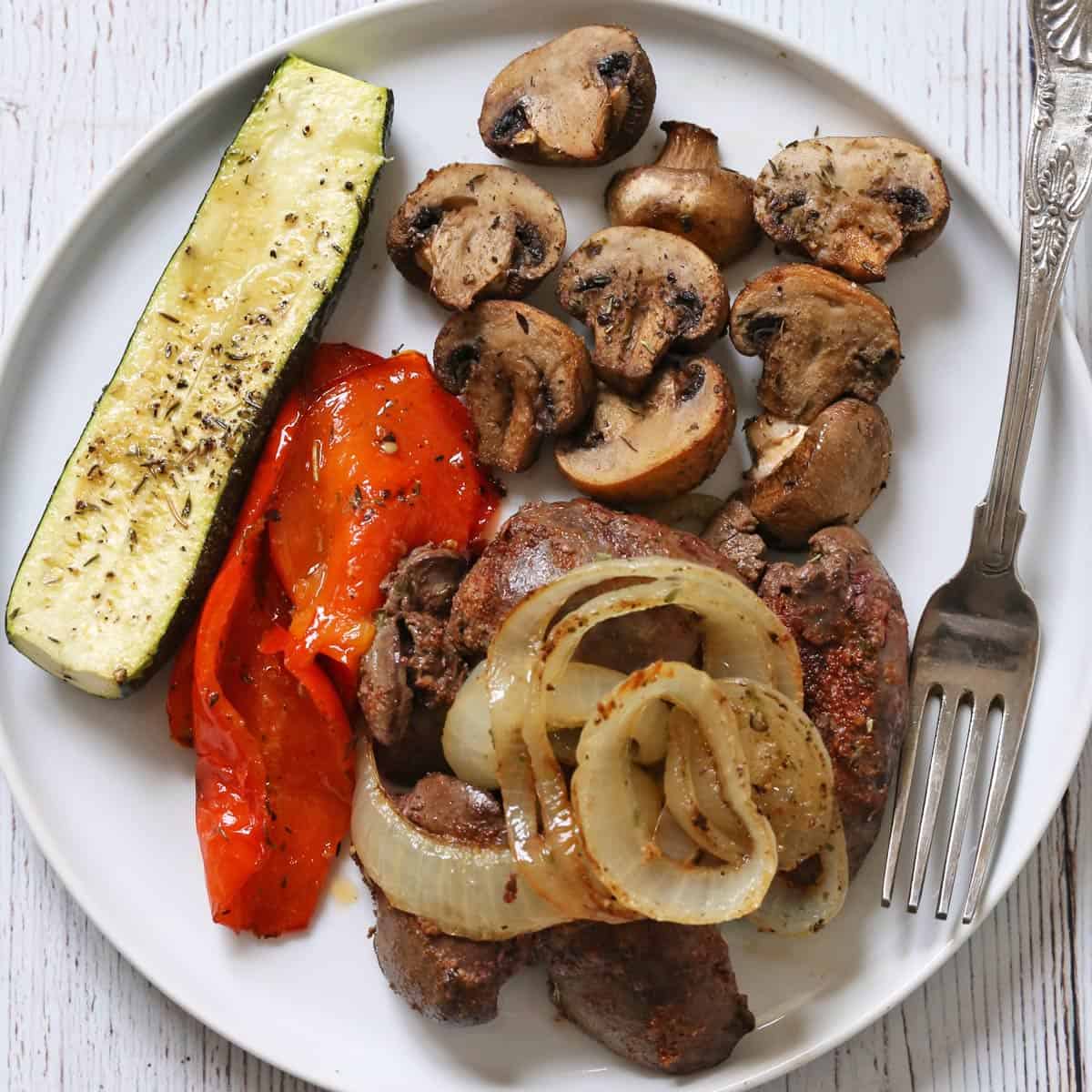 Chicken livers are served with roasted vegetables.