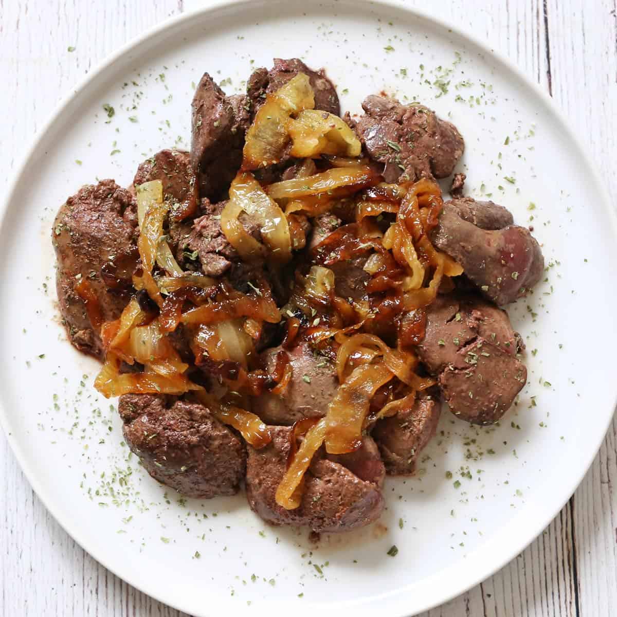 Chicken livers are topped with caramelized onions.