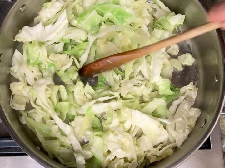 Cooking the cabbage in a deep skillet.