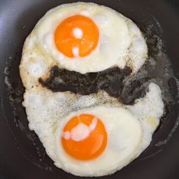 Two fried eggs in a skillet.