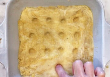 Making dimples in the dough.